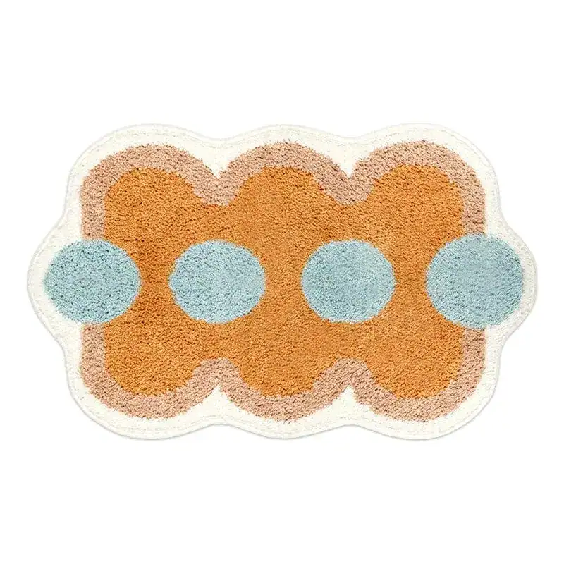 Orange Badezimmermatte mit blauen Punkten und welligem Rand.