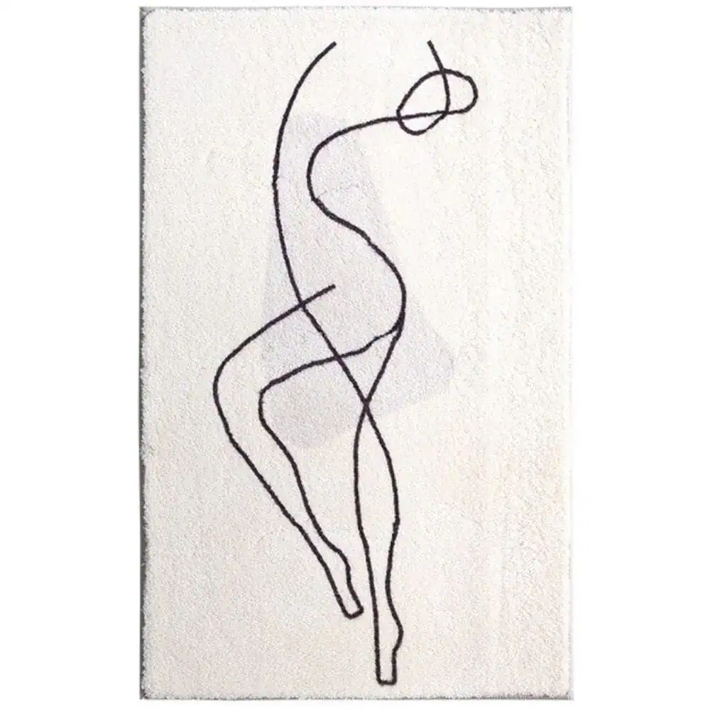 Grafisch gestalteter Badezimmerteppich mit schwarzem Linienmotiv auf cremefarbenem Untergrund.