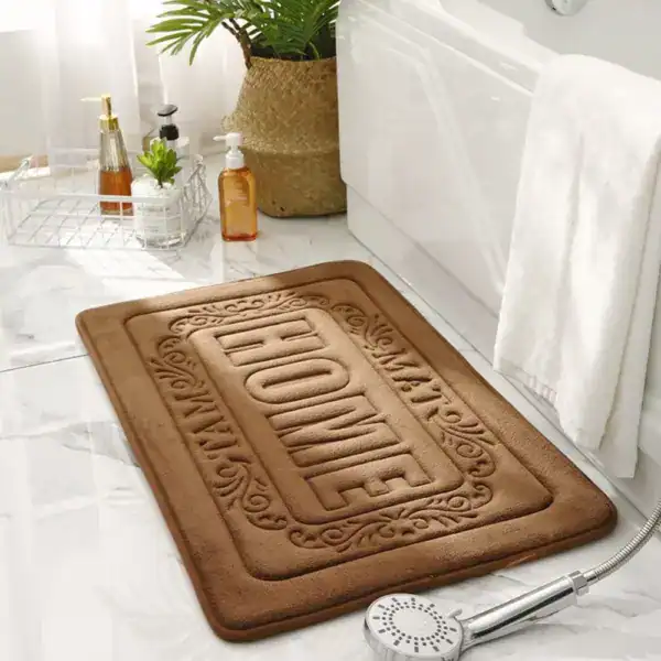 Rechteckiger Badezimmerteppich mit 'HOME'-Aufdruck, braun, für Bad und Dusche.