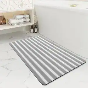 Grauer Badvorleger mit gerippter Struktur für optimale Trittsicherheit im Badezimmer.