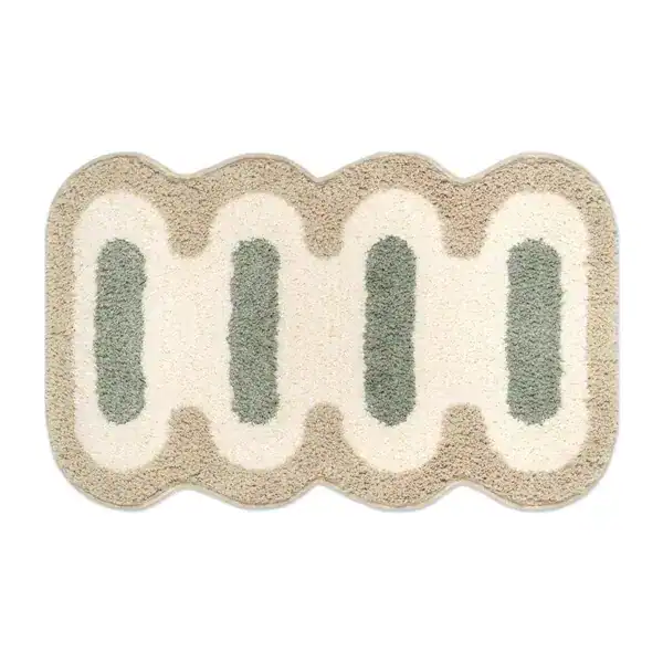 Kleine Badematte mit wellenförmigem Rand und grün-cremefarbenem Muster.