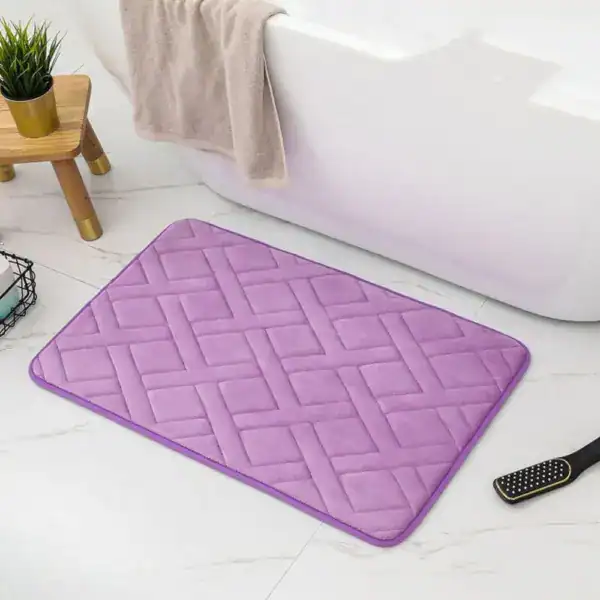Lila Weichschaum Badematte mit Quilt-Muster vor weißer Badewanne.